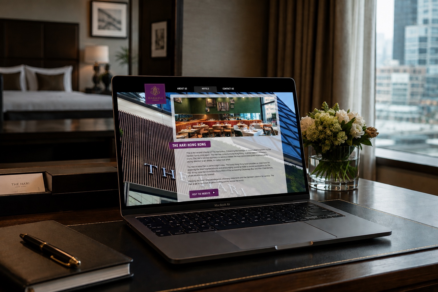 The Harilela Group website on a laptop in a Hari hotel room